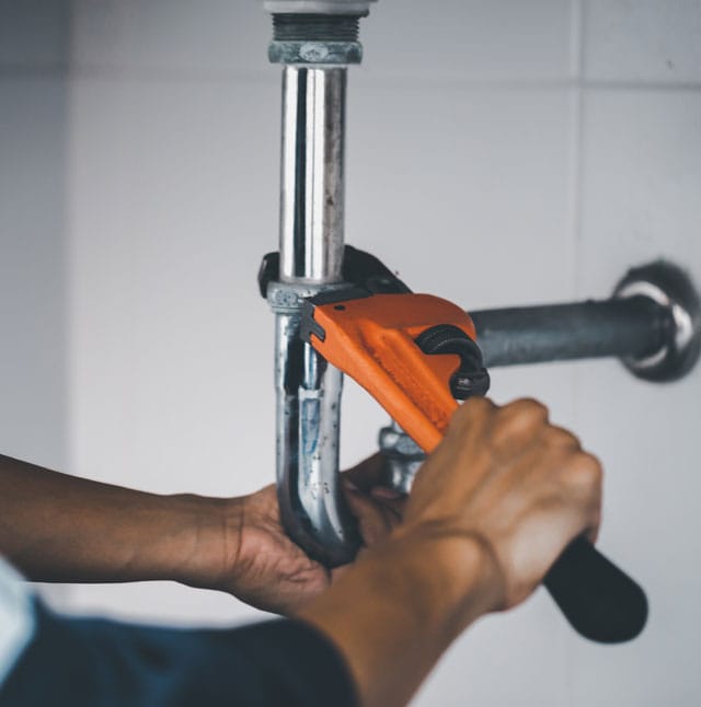plumber at work in a bathroom, plumbing repair service, assemble and install concept.
